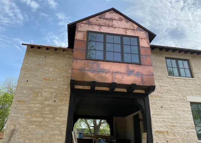 Copper metal panel facade on a stone building for Skylight Installation in Nashville