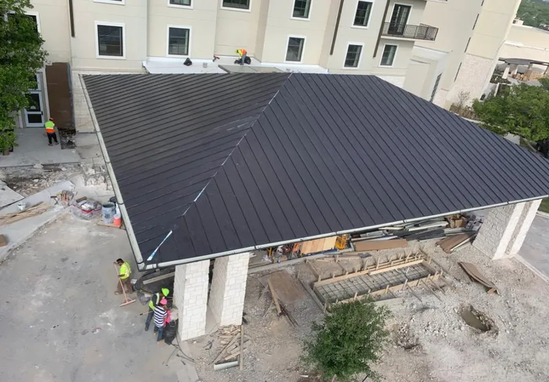 Metal roofing installation team working on a commercial building in Nashville